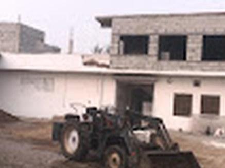 Farm building and yard with a tractor at Divin Mushroom Farm